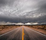 9815219-an-empty-desert-road-with-dark-and-foreboding-storm-clouds-on-the-horizon.jpg